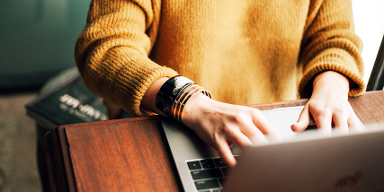 Hands using a laptop computer